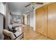 Bright bedroom featuring wood floors, a ceiling fan, a large closet, and comfortable seating at 375 Kohl St, Broomfield, CO 80020