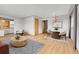 Open dining area with a chandelier, hardwood floors, and views to the living room at 375 Kohl St, Broomfield, CO 80020