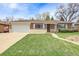 Well-maintained brick ranch-style home featuring a manicured front lawn and attached garage at 375 Kohl St, Broomfield, CO 80020