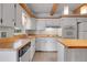 Bright kitchen with white cabinets, wood countertops and tile backsplash at 375 Kohl St, Broomfield, CO 80020