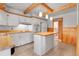 Bright kitchen featuring white cabinets, an island, and exposed wooden beams at 375 Kohl St, Broomfield, CO 80020
