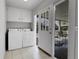 Laundry room with washer, dryer, cabinets and access to outdoor space at 375 Kohl St, Broomfield, CO 80020