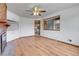 Bright living room with a fireplace, laminate floors, and open view to kitchen at 375 Kohl St, Broomfield, CO 80020