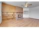 Inviting living room with brick fireplace, built-in shelving, and a ceiling fan at 375 Kohl St, Broomfield, CO 80020