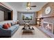 Cozy living room with brick fireplace, ceiling fan, and bright window at 375 Kohl St, Broomfield, CO 80020