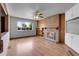 Cozy living room with brick fireplace, built-in shelves and laminate wood flooring at 375 Kohl St, Broomfield, CO 80020