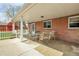 Covered brick patio furnished with a dining table and chairs; backyard and garden shed are visible at 375 Kohl St, Broomfield, CO 80020