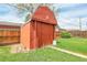 Garden shed with 'R' emblem, nestled in a green backyard with mature trees and landscaping at 375 Kohl St, Broomfield, CO 80020