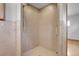 Close-up of the tiled shower with a glass door and modern fixtures at 375 Kohl St, Broomfield, CO 80020