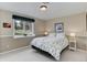 Cozy bedroom with natural light and a large window overlooking the landscaped backyard at 4133 Niblick Dr, Longmont, CO 80503