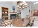 Bright dining room features an elegant chandelier, fireplace, and seamless flow into the kitchen at 4133 Niblick Dr, Longmont, CO 80503
