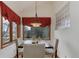 Dining room with natural light, wood-framed windows, and elegant chandelier at 4133 Niblick Dr, Longmont, CO 80503