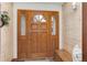 Entryway featuring a wooden front door, side windows, and decorative accents at 4133 Niblick Dr, Longmont, CO 80503