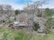 A charming home exterior with a deck, hot tub, a fire pit, a lush green lawn and beautiful mature trees at 4133 Niblick Dr, Longmont, CO 80503
