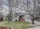 Charming home with inviting front porch, well-maintained lawn, and mature trees at 4133 Niblick Dr, Longmont, CO 80503