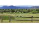 Scenic golf course view featuring lush greenery, sand traps and a distant mountain range at 4133 Niblick Dr, Longmont, CO 80503