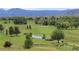 Picturesque view of the golf course with a water feature and mountain backdrop at 4133 Niblick Dr, Longmont, CO 80503