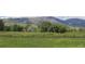 Expansive golf course view framed by a rustic wooden fence and distant mountain range at 4133 Niblick Dr, Longmont, CO 80503
