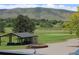 Scenic view of a golf course, rolling hills, and mountain backdrop creating a tranquil setting at 4133 Niblick Dr, Longmont, CO 80503