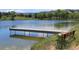 Picturesque lake with a fishing dock and relaxing bench with mountain views at 4133 Niblick Dr, Longmont, CO 80503