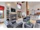 A bright and airy living room featuring a fireplace, vaulted ceilings, and hardwood floors at 4133 Niblick Dr, Longmont, CO 80503