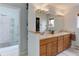 Bright main bathroom features dual sinks, a large mirror, and a glass enclosed shower at 4133 Niblick Dr, Longmont, CO 80503