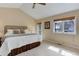 Comfortable main bedroom features a vaulted ceiling, ceiling fan, window, and access to outdoor patio at 4133 Niblick Dr, Longmont, CO 80503