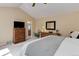 Bright main bedroom features a ceiling fan, vaulted ceilings, and access to the ensuite bathroom at 4133 Niblick Dr, Longmont, CO 80503
