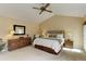 Comfortable main bedroom features a vaulted ceiling, ceiling fan, and ample natural light from windows at 4133 Niblick Dr, Longmont, CO 80503
