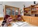 Office space with wood built-ins, natural light, and comfortable seating area at 4133 Niblick Dr, Longmont, CO 80503