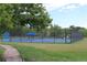 Well-maintained tennis courts with fencing, surrounded by lush greenery, offering a great recreational amenity at 4133 Niblick Dr, Longmont, CO 80503