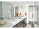 Bathroom features double sinks, marble countertops, and a glass-enclosed shower at 1581 Wolff St, Denver, CO 80204