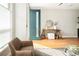 Bright entryway with stylish decor and a modern teal front door at 1581 Wolff St, Denver, CO 80204