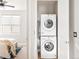 Convenient laundry closet with stacked washer and dryer units, maximizing space and adding efficiency to everyday living at 1581 Wolff St, Denver, CO 80204