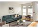 Sun-filled living room boasts hardwood floors, neutral tones, and large windows with natural light at 1581 Wolff St, Denver, CO 80204