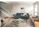 Bright and airy living room with hardwood floors, a stylish rug, and modern seating arrangement at 1581 Wolff St, Denver, CO 80204