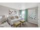 Cozy bedroom features a daybed, stylish throw pillows and two ottomans at 4837 Cattle Cross Ln, Castle Rock, CO 80104