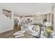 Open-concept living room connected to the dining area and kitchen with modern decor and lots of light at 4837 Cattle Cross Ln, Castle Rock, CO 80104