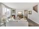 Bright living room with a fireplace, large windows, modern furnishings, and stylish decor at 4837 Cattle Cross Ln, Castle Rock, CO 80104