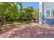 Landscaped backyard features stone patio, dining area, and expansive lawn, perfect for entertaining at 1540 Meachum Way, Erie, CO 80516