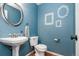 Stylish powder room featuring designer vanity, decorative mirrors, and neutral fixtures at 1540 Meachum Way, Erie, CO 80516