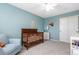 Comfortable Bedroom boasts blue walls, wood crib, and a plush armchair at 1540 Meachum Way, Erie, CO 80516