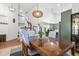 Elegant dining room featuring vaulted ceiling, stylish light fixture, and easy access to kitchen at 1540 Meachum Way, Erie, CO 80516