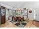 Bright dining area with large windows, hardwood floors, and modern light fixture at 1540 Meachum Way, Erie, CO 80516