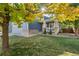 Beautiful home showcasing well-maintained lawn, lush trees, and welcoming front porch at 1540 Meachum Way, Erie, CO 80516