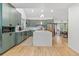 Open-concept kitchen with stainless steel appliances, large island, and seamless flow to dining at 1540 Meachum Way, Erie, CO 80516