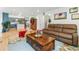 Open living room features hardwood floors and seamless flow into the kitchen at 1540 Meachum Way, Erie, CO 80516