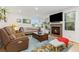 Bright living room features a cozy fireplace, large windows and hardwood floors at 1540 Meachum Way, Erie, CO 80516