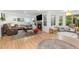 Bright living room features a cozy fireplace, large windows and hardwood floors at 1540 Meachum Way, Erie, CO 80516