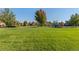 Expansive park featuring a playground, well-manicured lawn, mature trees, and walking paths at 1540 Meachum Way, Erie, CO 80516